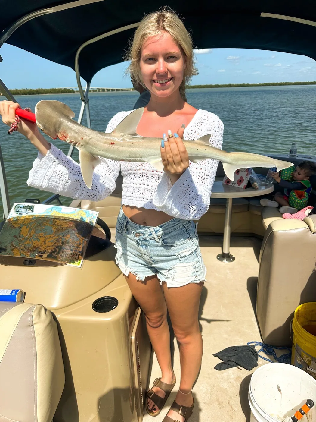 Young angler with a snook on the boat