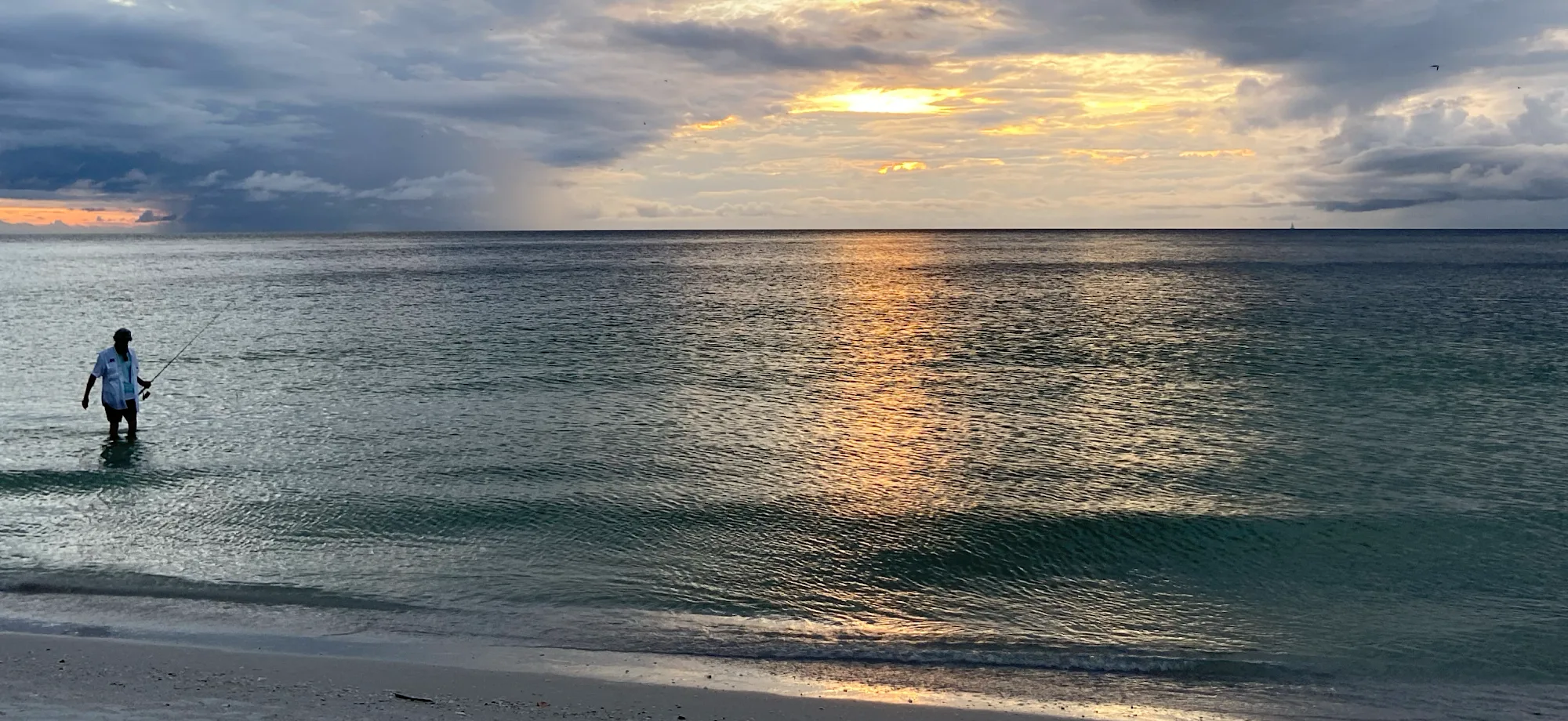 An angler wading at sunset off Marco Island